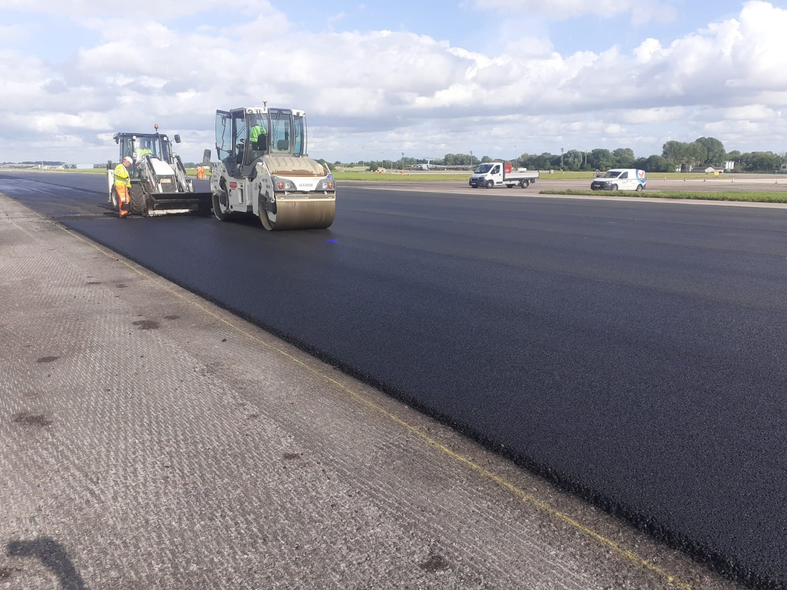 Photo - Vehicles and operators carrying out maintenance to the runway at RAF Brize Norton